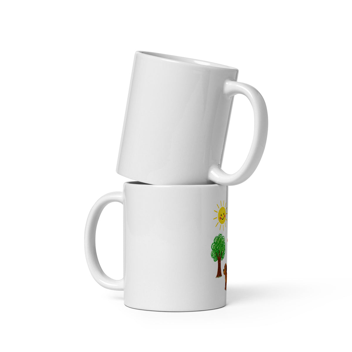 Two white glossy 11 oz mugs stacked together, one printed with a child's crayon drawing of a sun, tree and dog